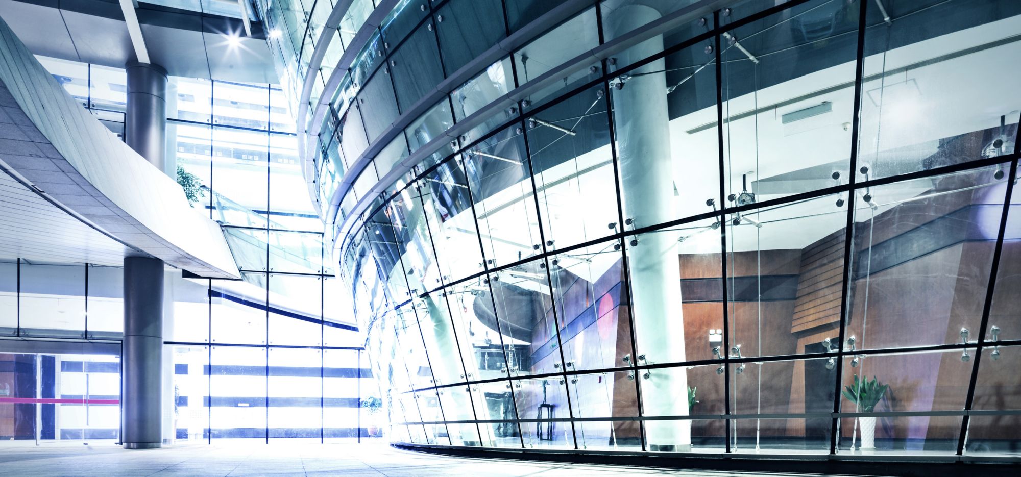 Modern glass building facade with bright lighting 